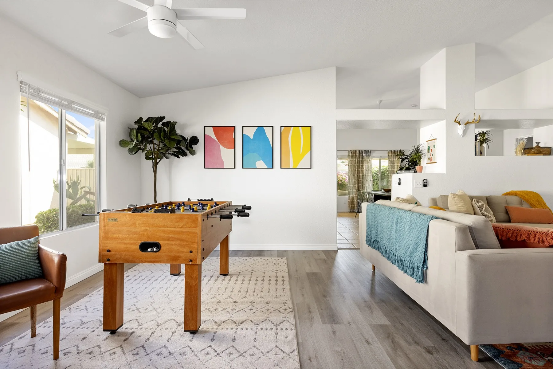 The Cozy Cactus game room with foosball table, abstract art, and living area in Indio California