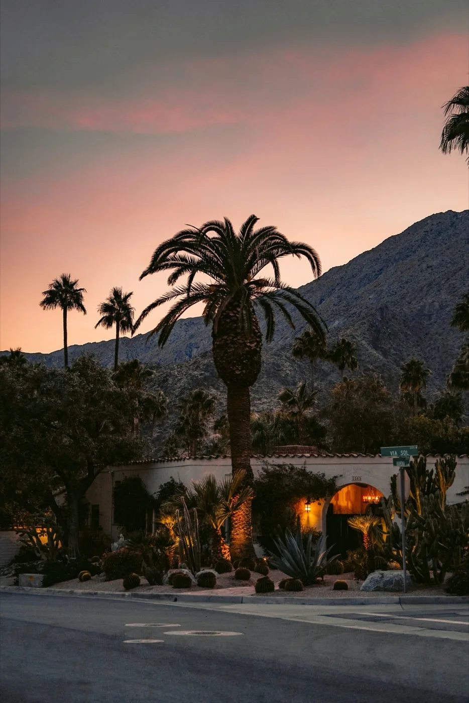 Palm Springs sunset with orange light over the desert valley and silhouetted palm trees