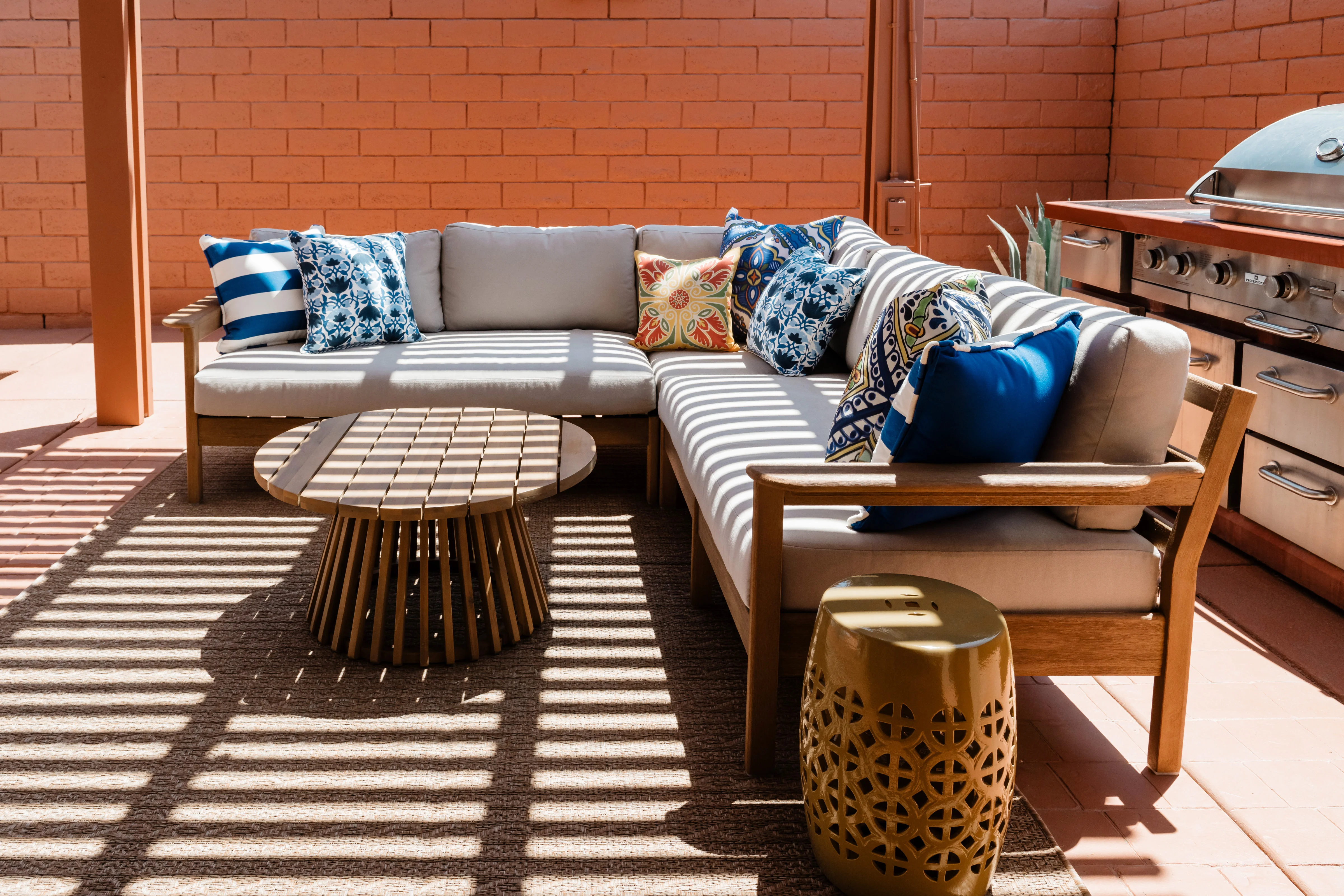 Covered outdoor patio at Terra Luz with terracotta walls and string lights at evening