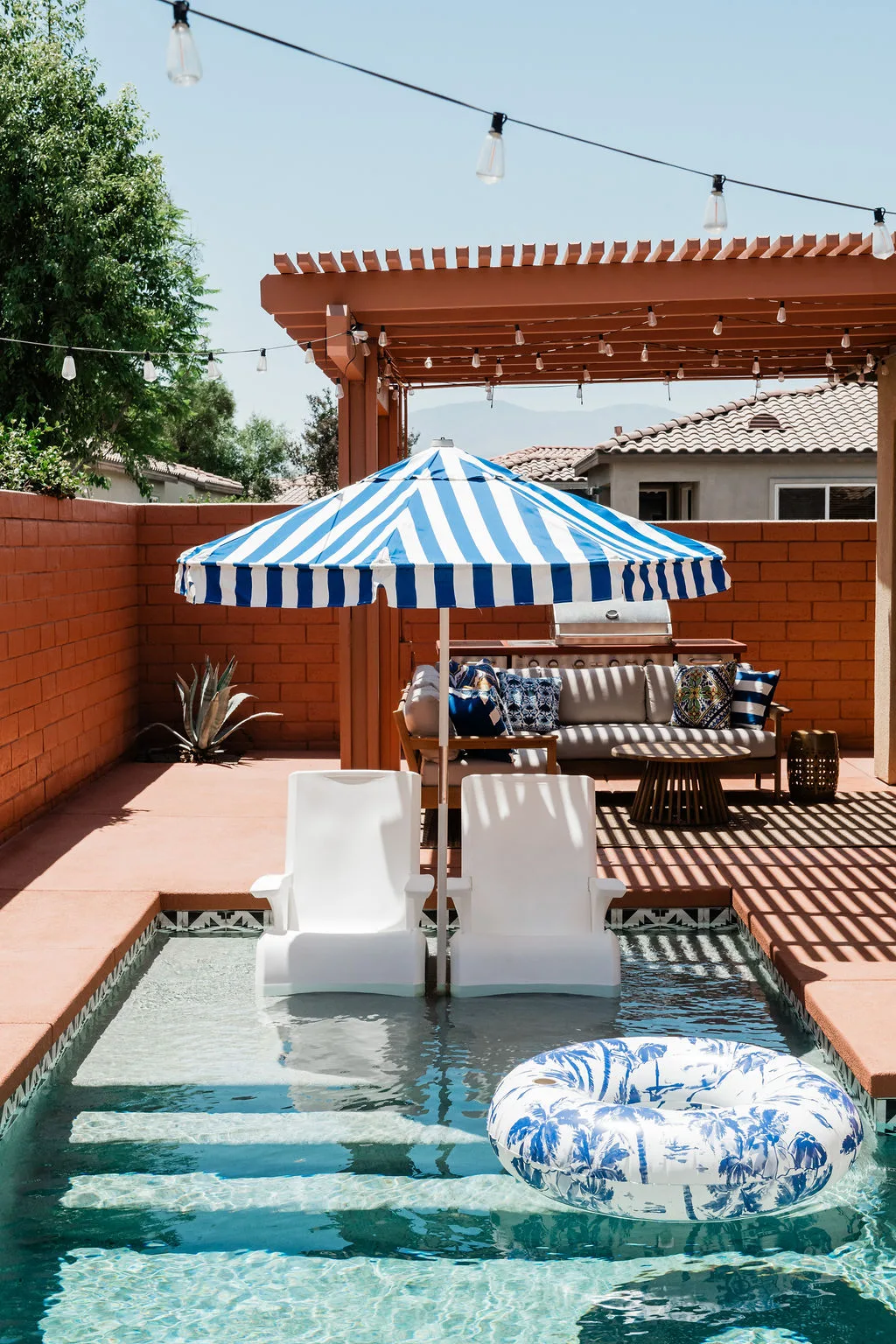 Terra Luz saltwater pool with in-water loungers and terracotta deck in Indian Palms Country Club, Indio CA