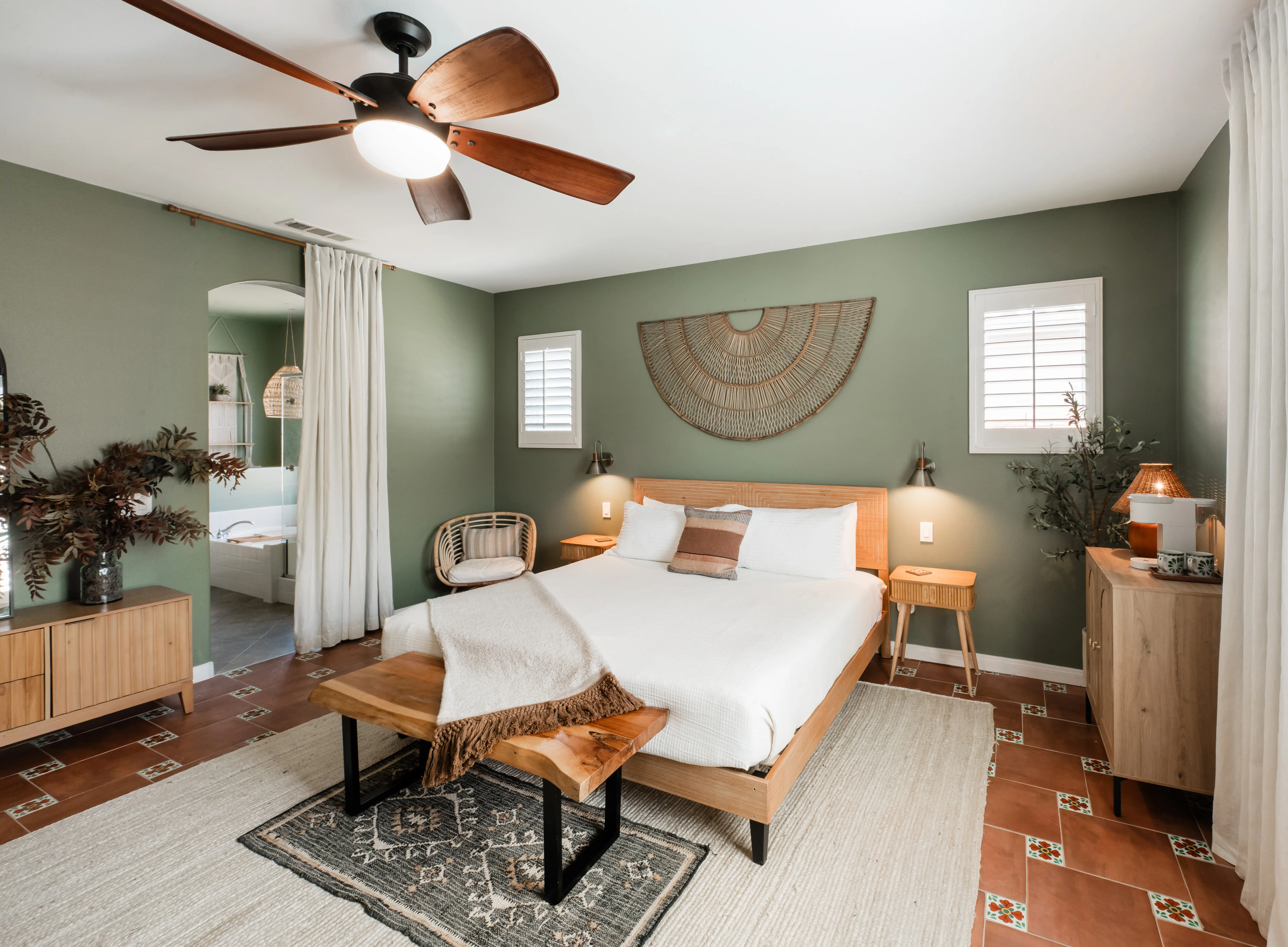 Terra Luz primary bedroom with king bed, sage green walls, and Old Havana-inspired desert palette in Indio California