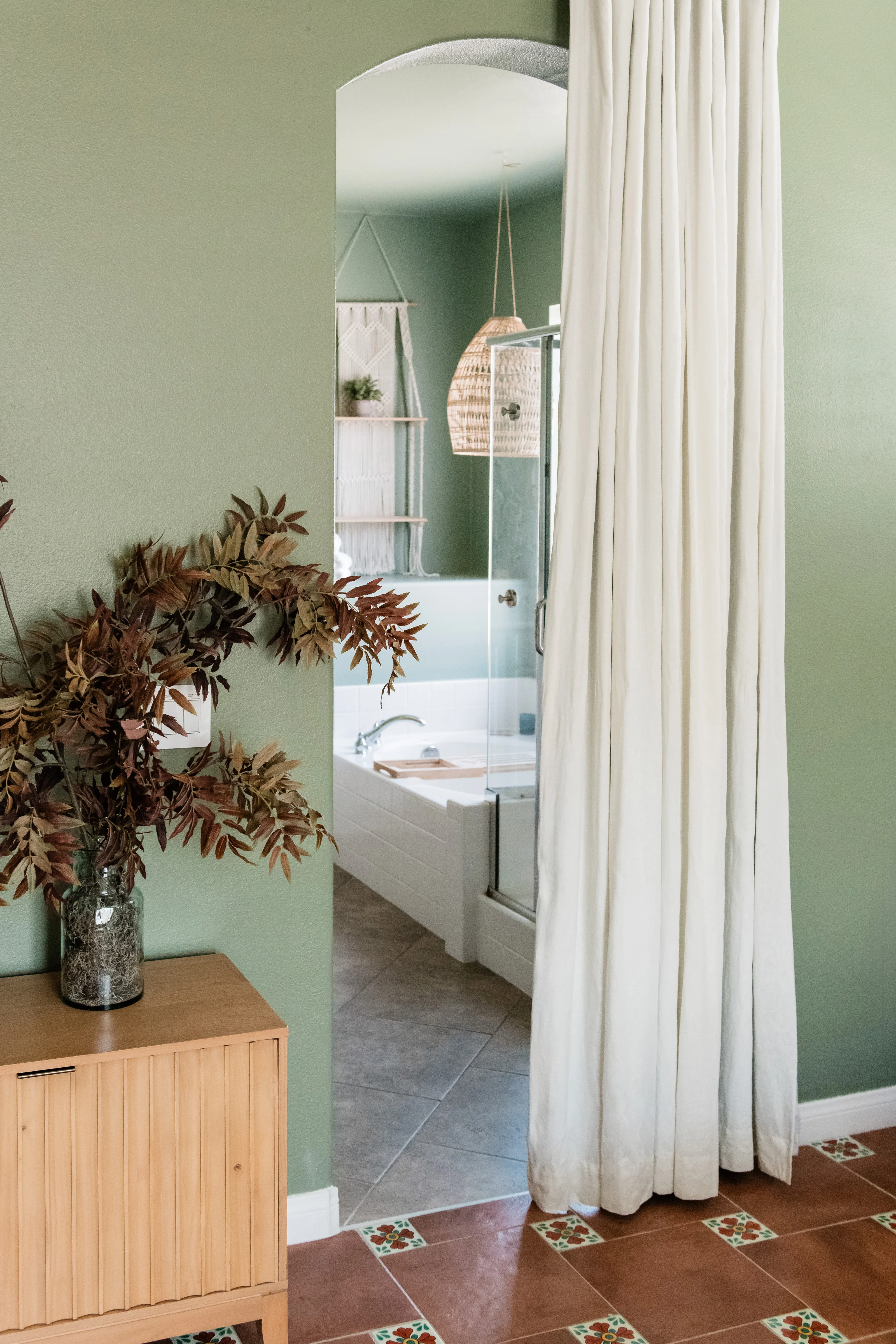 Terracotta tile floor with hand-painted Talavera accent tiles at corners in the primary bedroom at Terra Luz vacation rental in Indio