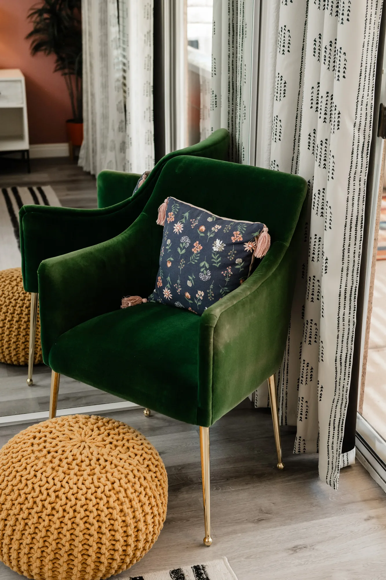 Cozy Cactus primary bedroom sitting area with two green velvet chairs and mustard knit pouf
