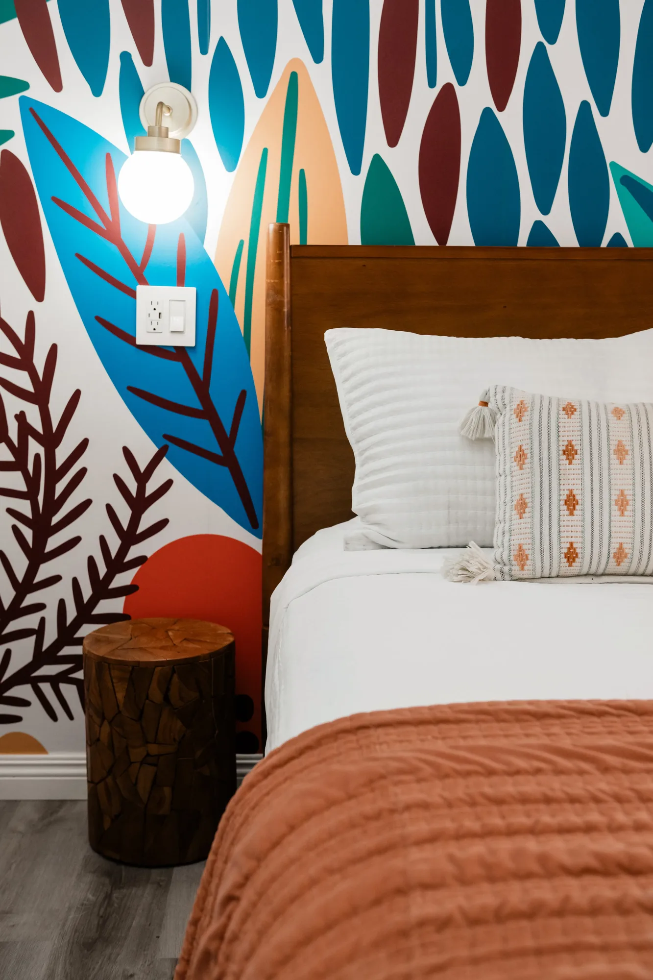 Cozy Cactus second bedroom with floor-to-ceiling surfboard botanical mural and terracotta bedding
