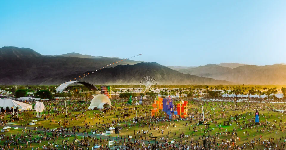 Coachella festival grounds aerial view with mountains at sunset