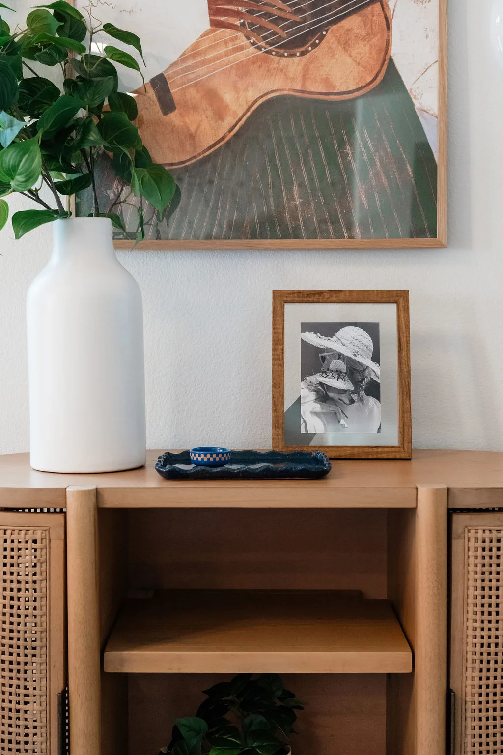 Terra Luz living room walnut credenza with warm afternoon light and bookcase full of actual books