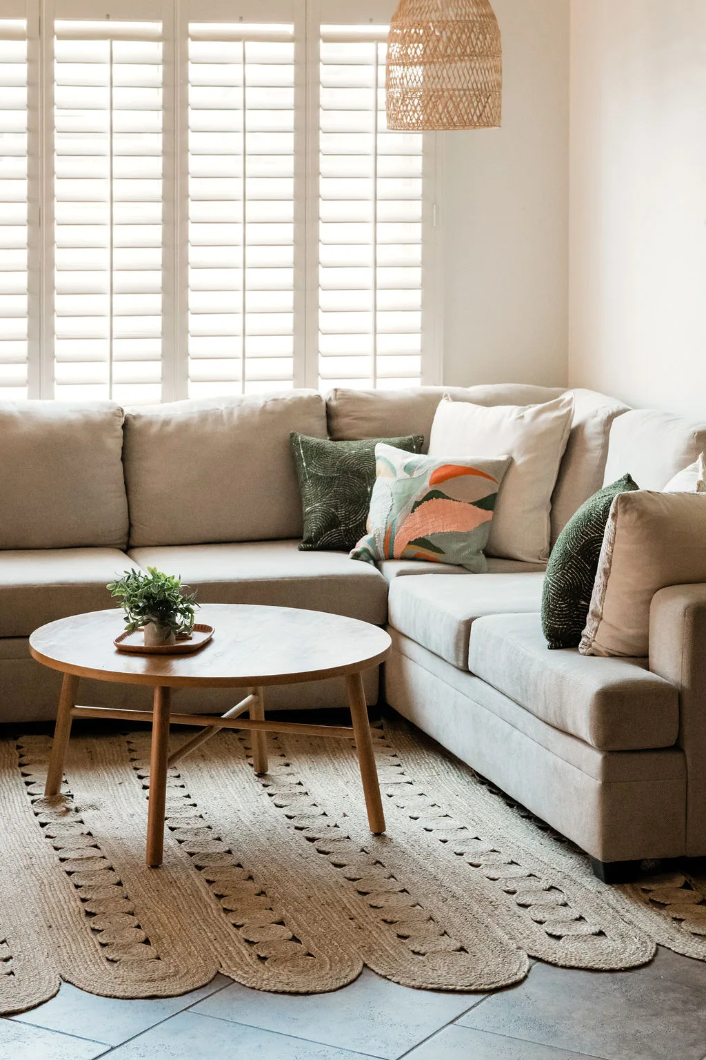 Terra Luz living room from hallway showing full rattan seating arrangement and bookcase