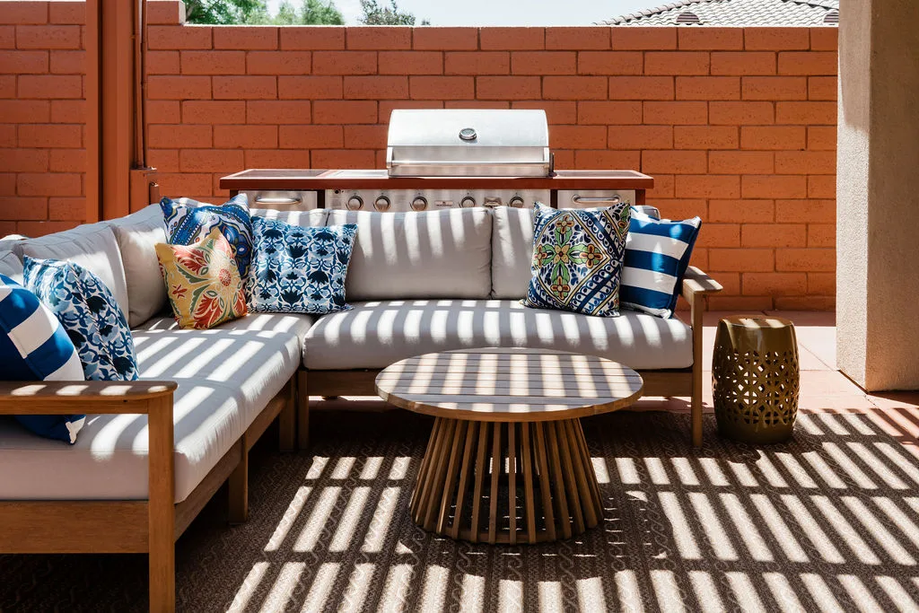 Terra Luz covered patio with pergola string lights, terracotta deck, and desert mountain backdrop at dusk