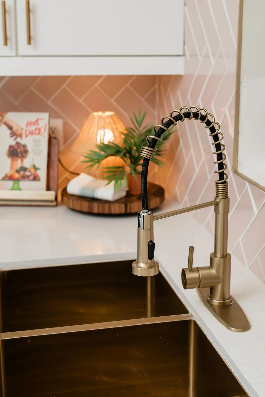 The Sundune Palm Springs kitchen gold spring faucet with pink herringbone tile