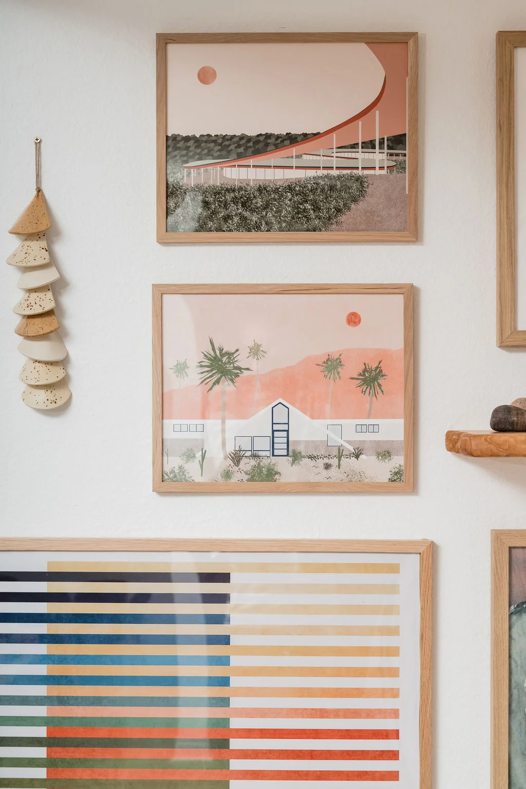 The Sundune Palm Springs living room art gallery wall with curated surf and coastal photography
